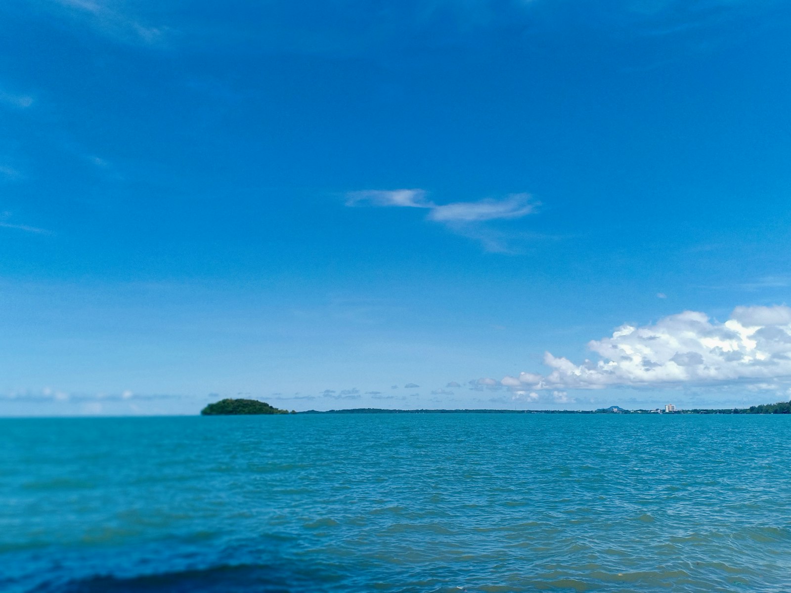 a body of water with a small island in the distance