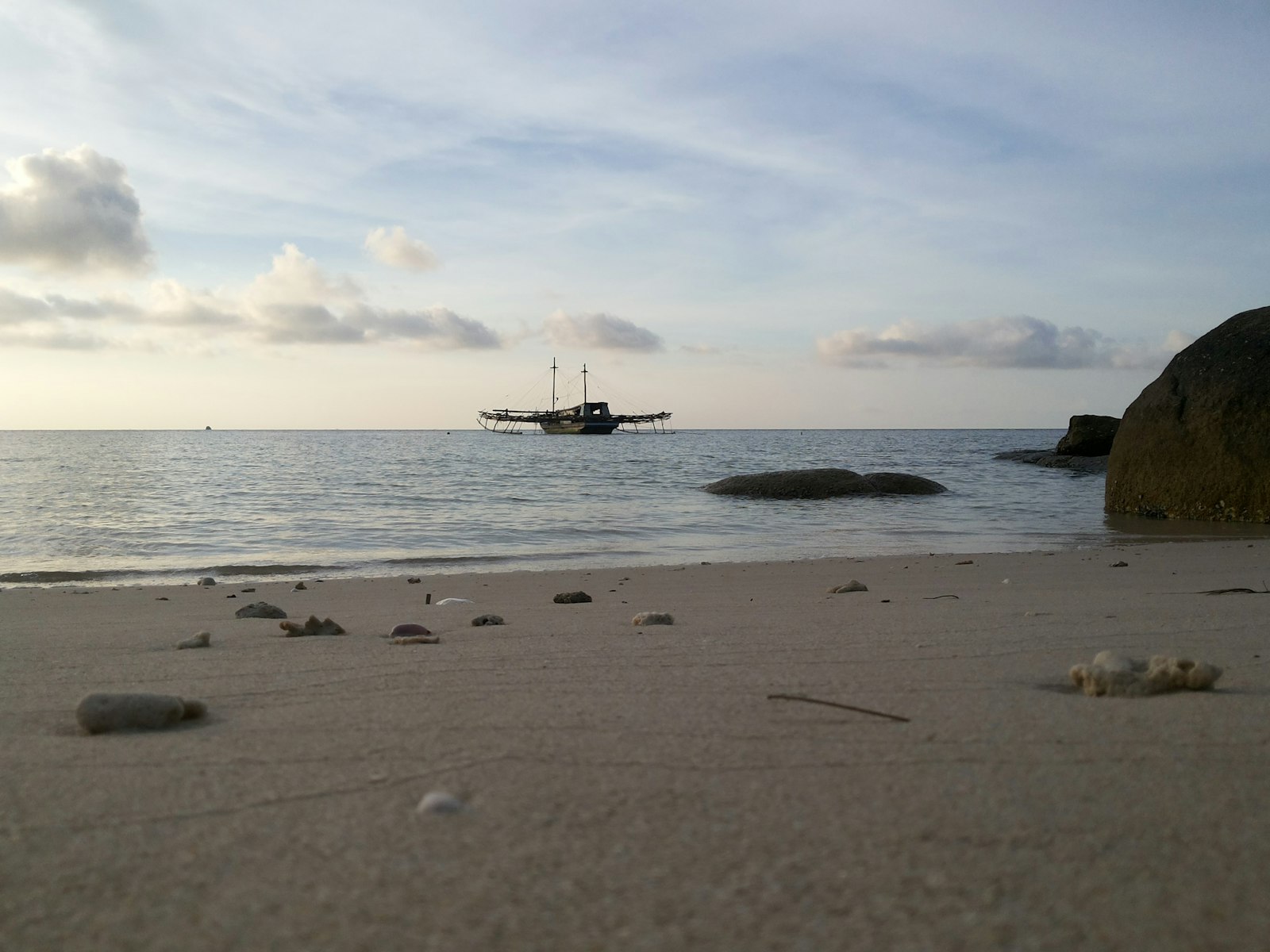 a boat is in the distance on the water