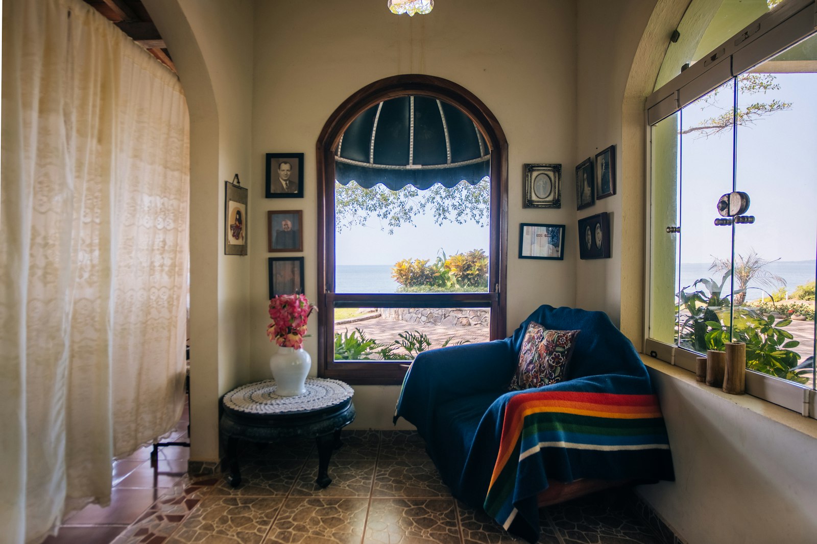 Cozy reading nook with ocean view and armchair.