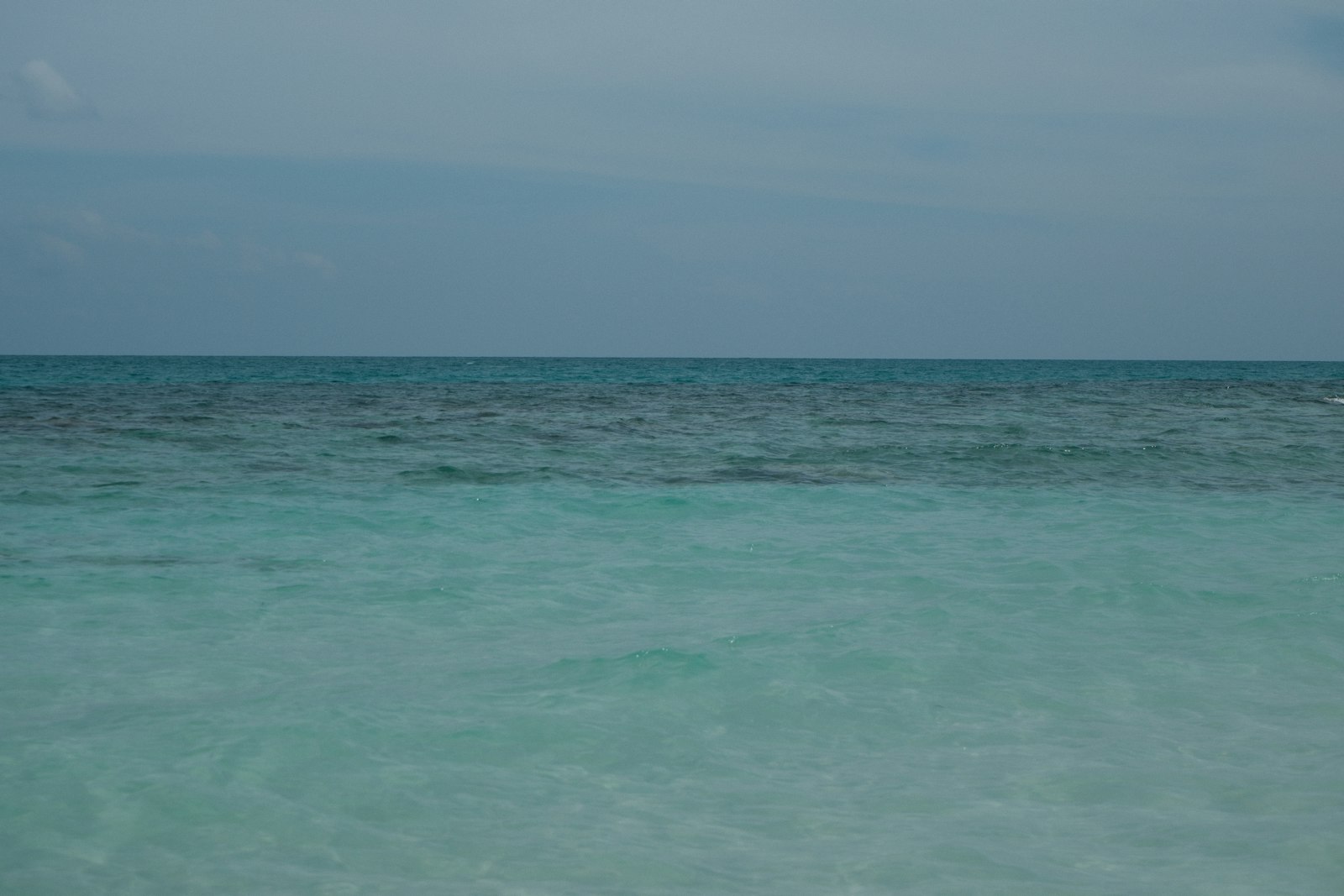 Calm ocean water under a cloudy sky